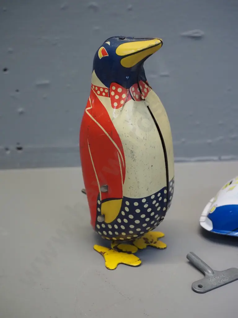 2 tin-plate toys - wind-up penguin H150, some fading, going but weak action, and a friction drive "St. John" brand Image 1++