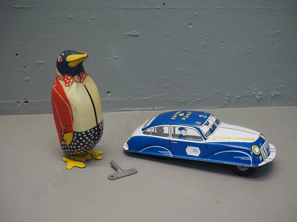 2 tin-plate toys - wind-up penguin H150, some fading, going but weak action, and a friction drive "St. John" brand Image 1++