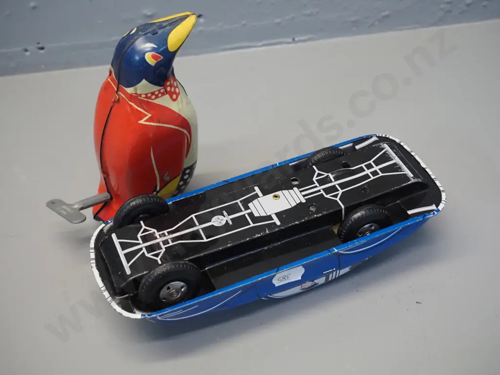 2 tin-plate toys - wind-up penguin H150, some fading, going but weak action, and a friction drive "St. John" brand Image 1++