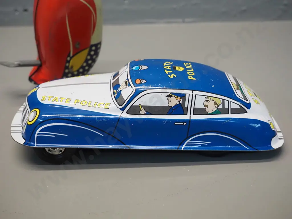 2 tin-plate toys - wind-up penguin H150, some fading, going but weak action, and a friction drive "St. John" brand Image 1++