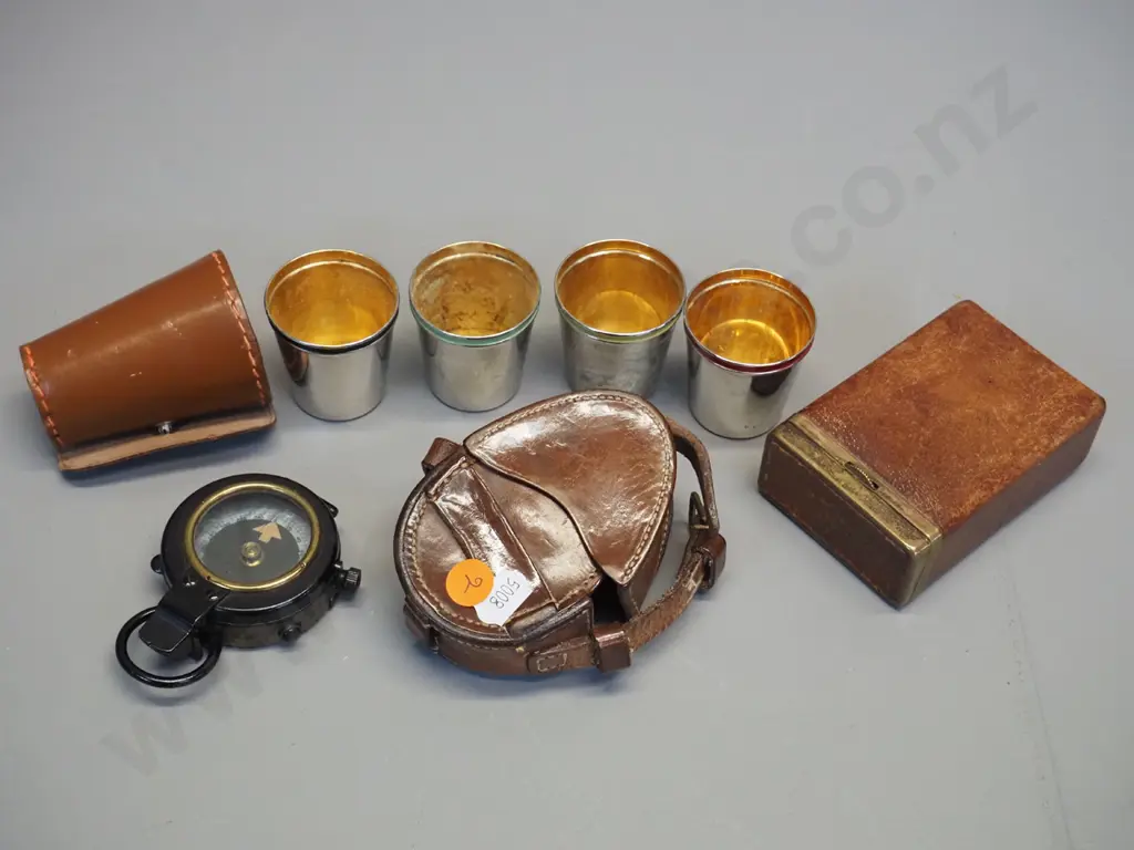 leather cased Lawrence & Mayo London prismatic service compass, a set of 4 silver plated nip cups with multi colour Image 1++
