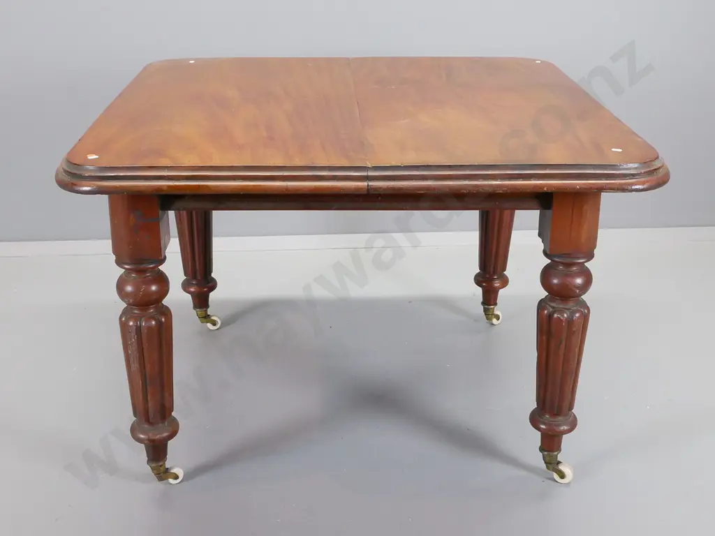 vVctorian mahogany wind-out dining table with fluted turned legs and white porcelain casters Image 1++