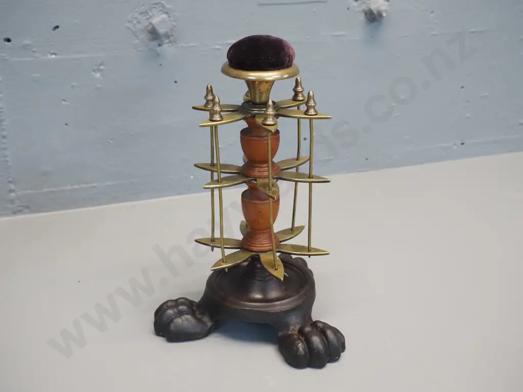 brass and timber vintage sewing stand on 3-footed cast iron base with pin cushion on top and removable thread spool Image 1++