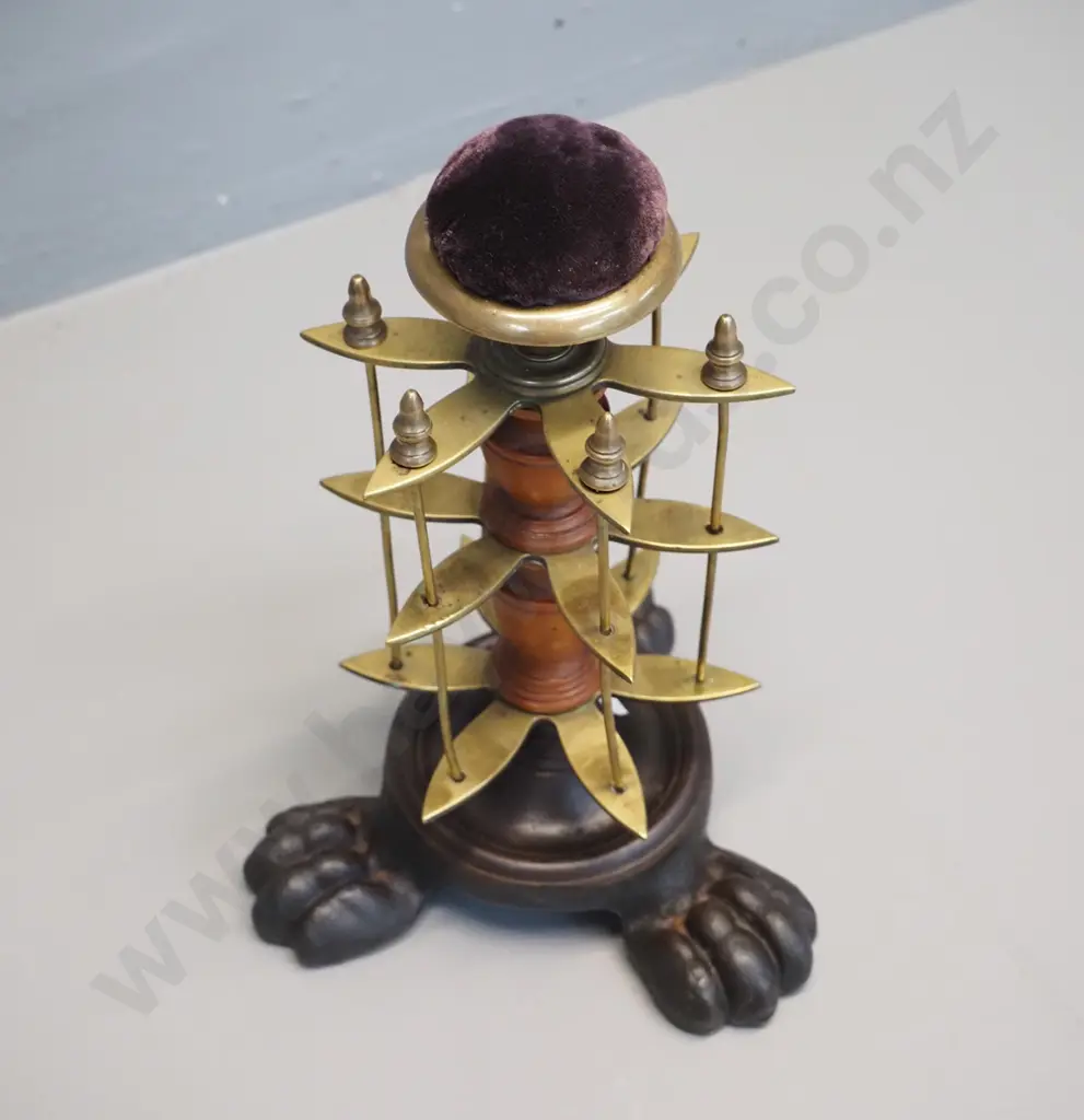 brass and timber vintage sewing stand on 3-footed cast iron base with pin cushion on top and removable thread spool Image 1++