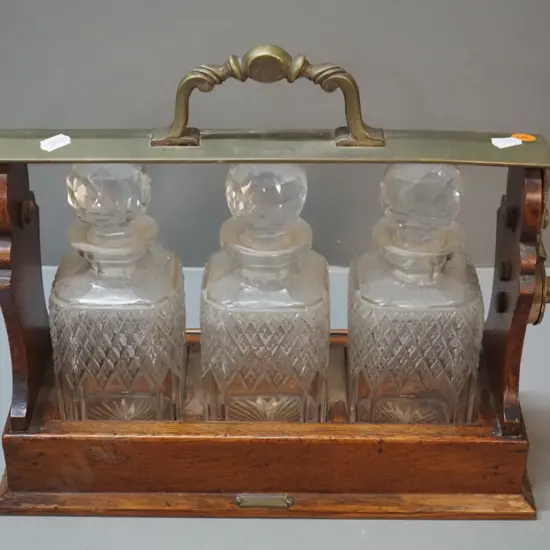 oak drinks tantalus with 3 crystal stoppered decanter, small "R. Stewart Glasgow" plaque, locked and no key
