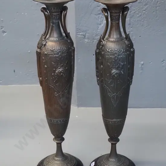 pair of classical style cast metal stands or candle holders with painted steel bases - slightly loose stem near base on