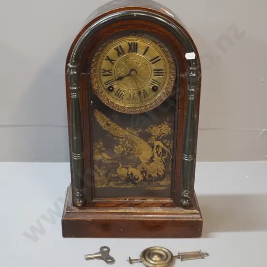 vintage arch-shaped timber-cased mantel clock with gilt patterned glass - some finish loss on face. With key & pendulum,