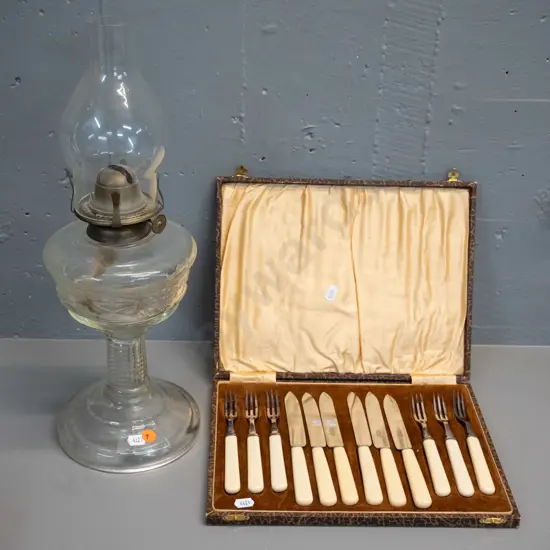 clear glass kerosene lamp H-420 and a cased set of bone-handled dessert knives and forks