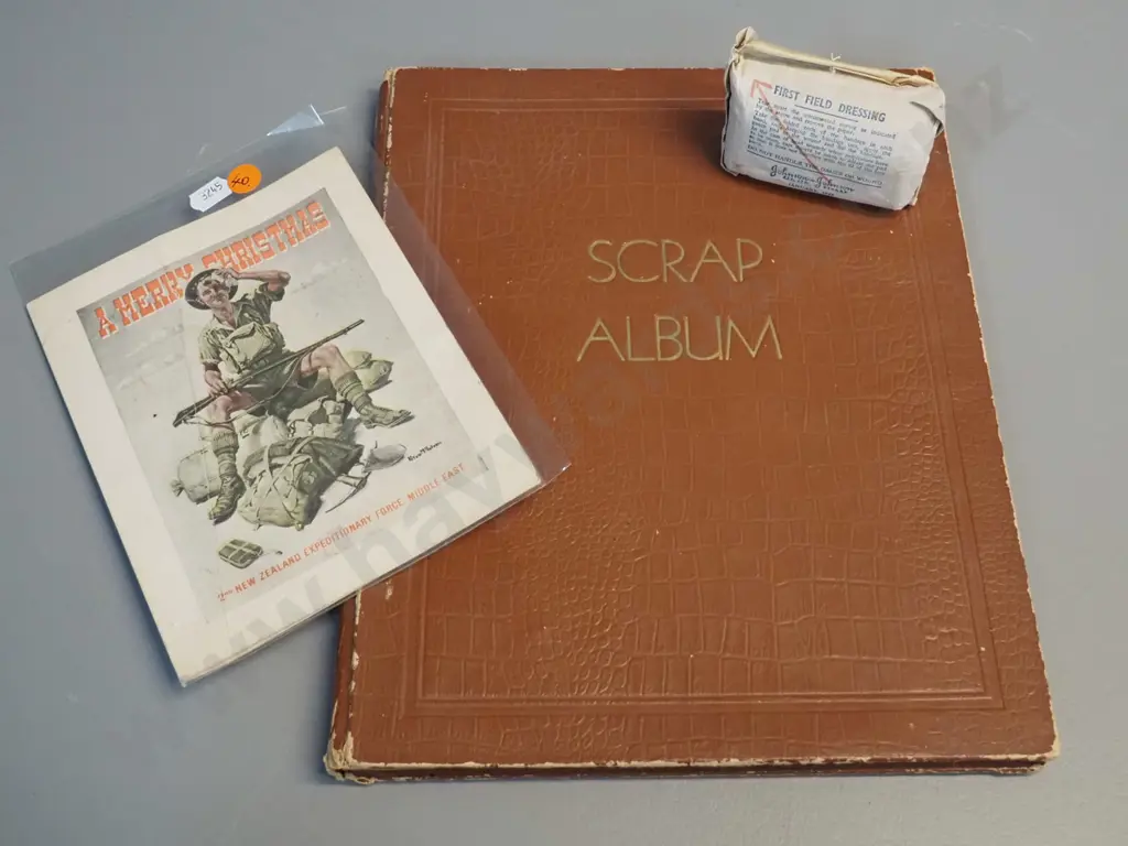 WWII era ephemera - 1941 NZEF Christmas card, 1942 field dressing and a scrapbook w/ cartoons, some foxing Image 1++