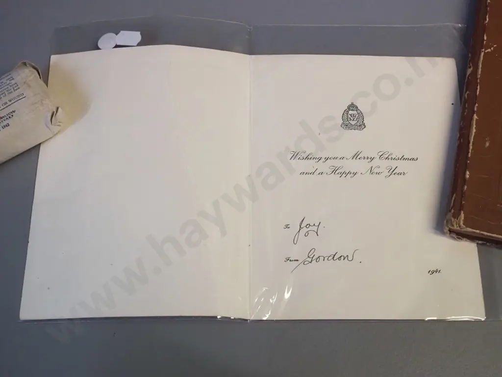 WWII era ephemera - 1941 NZEF Christmas card, 1942 field dressing and a scrapbook w/ cartoons, some foxing Image 1++