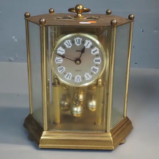 "Koma" German anniversary clock in brass and glass case, quartz movement H-230 W-200 D-130