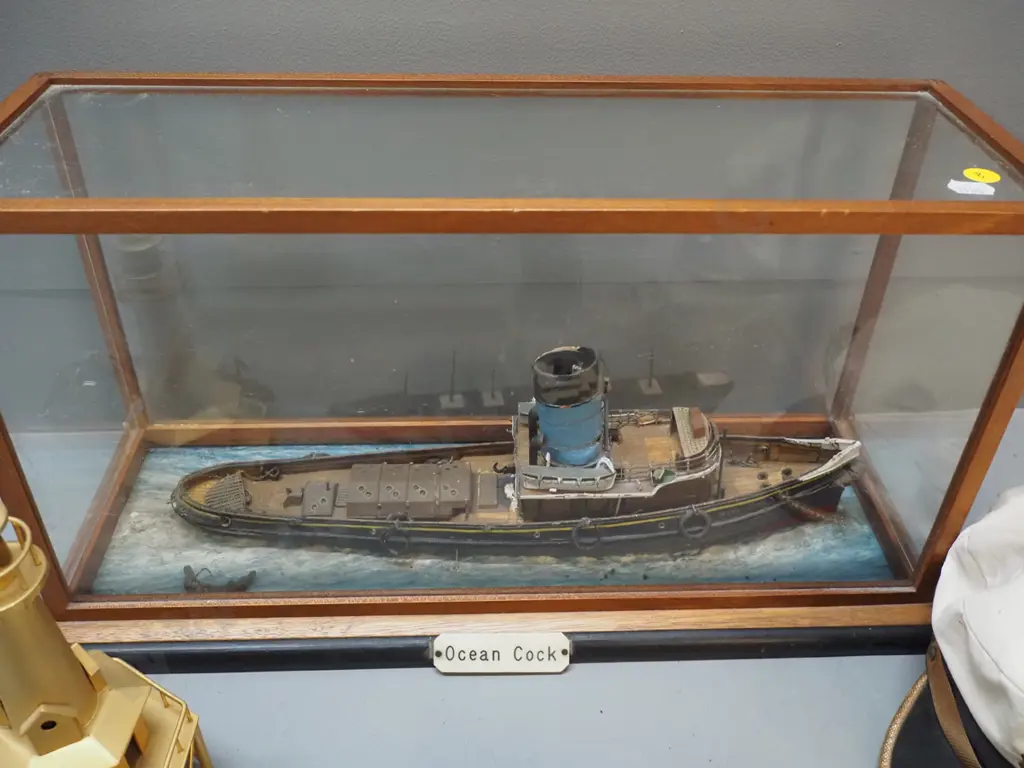 "Ocean Cock" steamer / tugboat in timber and glass case, a captain's hat, small glass float, modern brass lighthouse, Image 1++