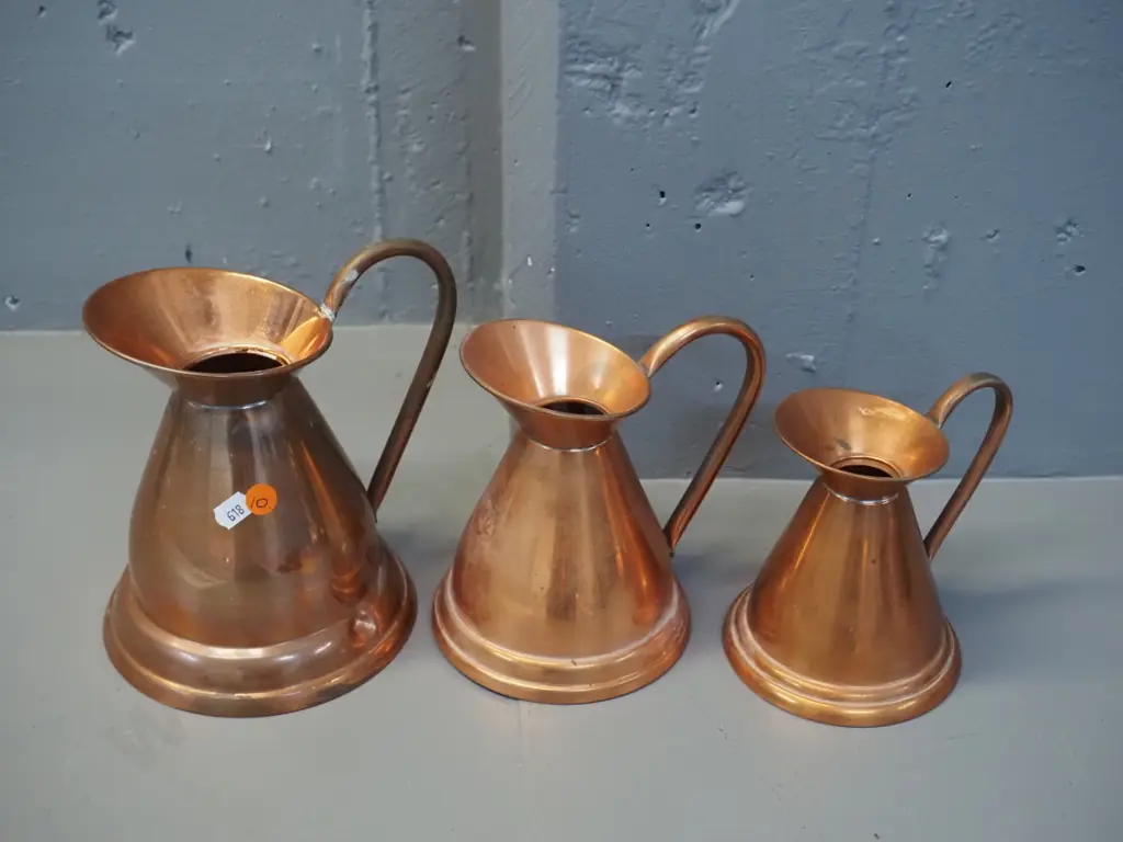 graduated set of 3 copper jugs -  marked Longbard England. Largest has a dent H-200 W-190 Image 1++