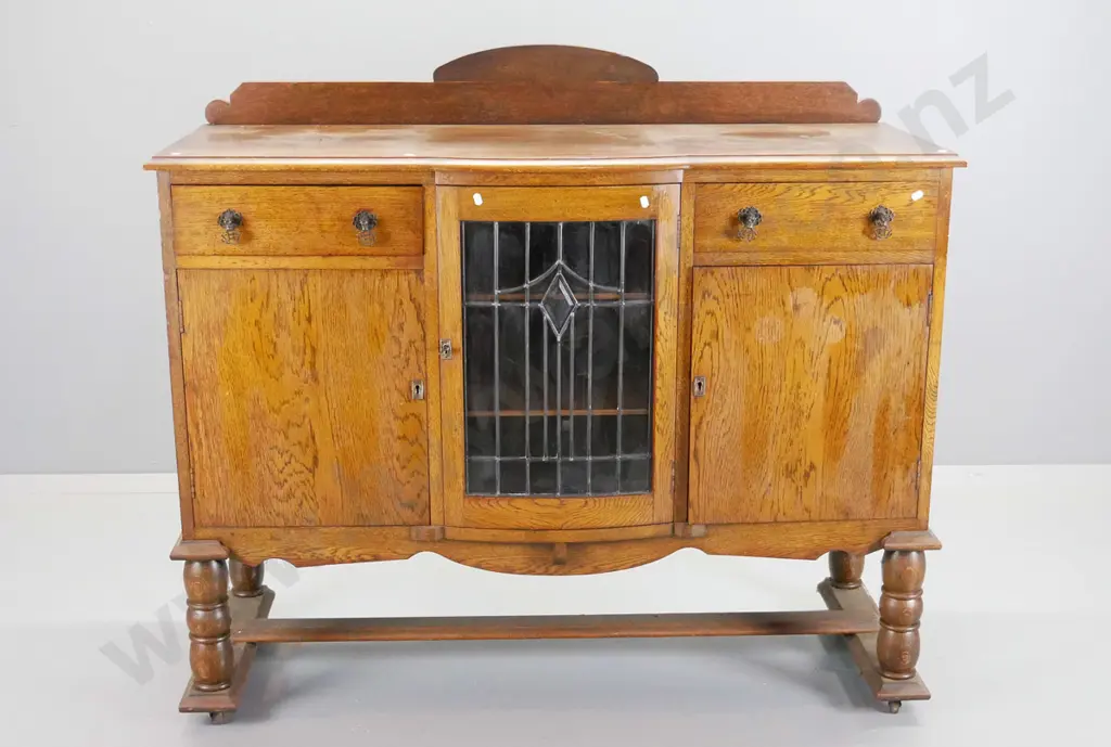 deco oak sideboard with 2 drawers, 2 solid and 1 leadlight doors, turned legs, stretcher base on casters - polish needs Image 1++