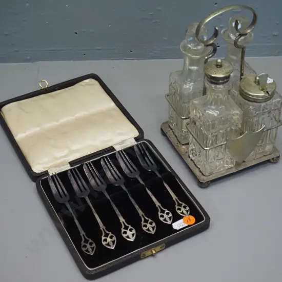 cased set of 6 sterling silver cake forks and a plated and glass 4-piece condiment set and stand with prize dedication