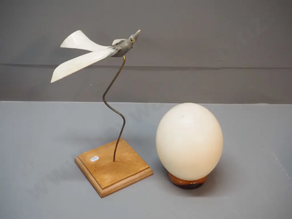 ostrich egg with wooden stand and a flying bird figure made of horn on a wooden stand H-310 Image 1++