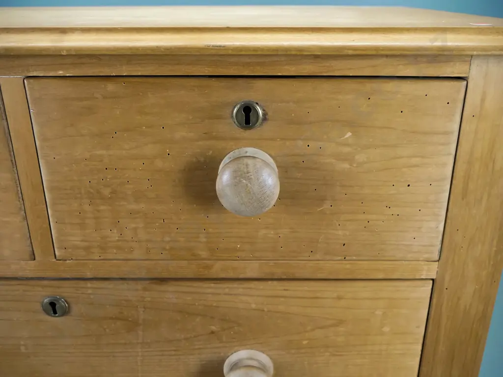 colonial kauri four drawer chest round cornered having brass escutcheons, wooden knobs, some borer Image 1++