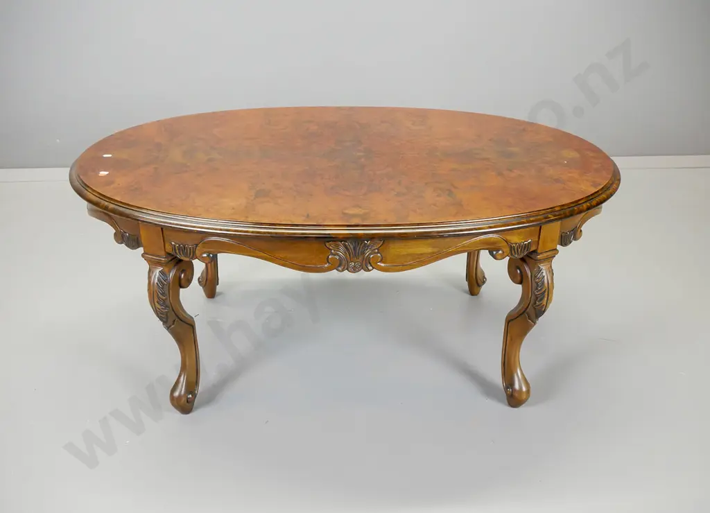 reproduction walnut and mahogany oval coffee table having scrolling shaped apron, Image 1++