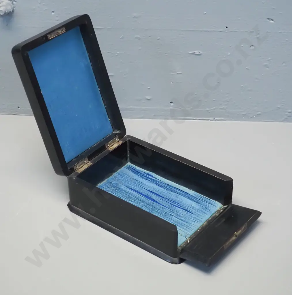 vintage ebonised timber box with hinged top and front, gilt decoration on top, has chip to base, wear to fabric lining. Image 1++