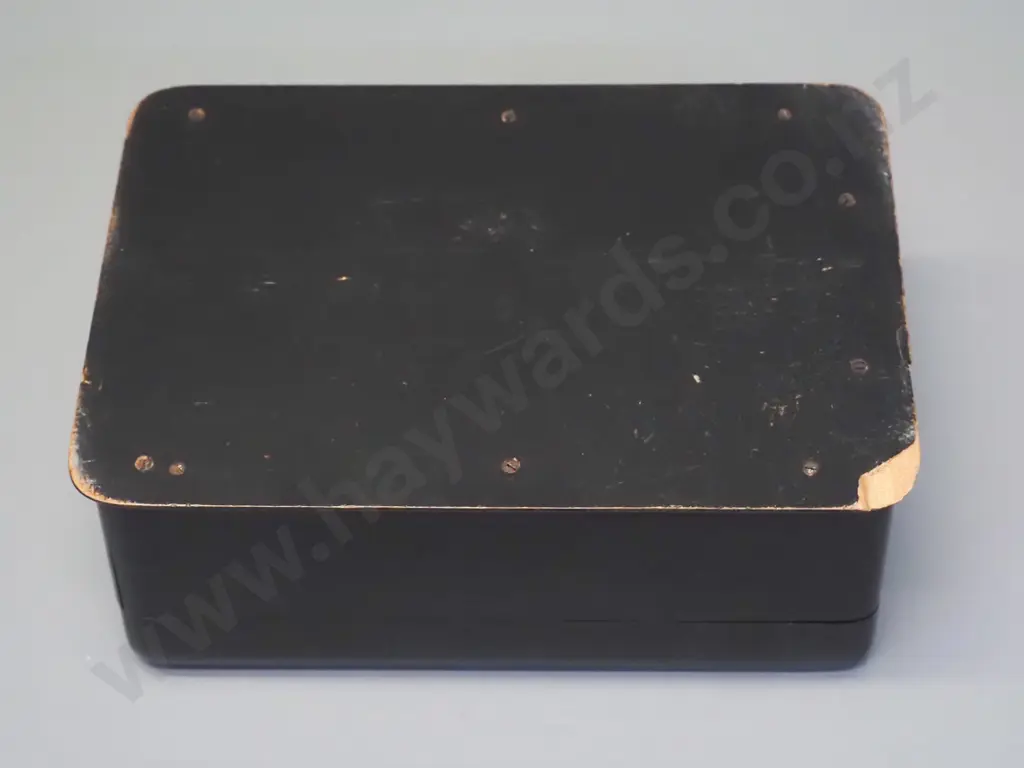 vintage ebonised timber box with hinged top and front, gilt decoration on top, has chip to base, wear to fabric lining. Image 1++
