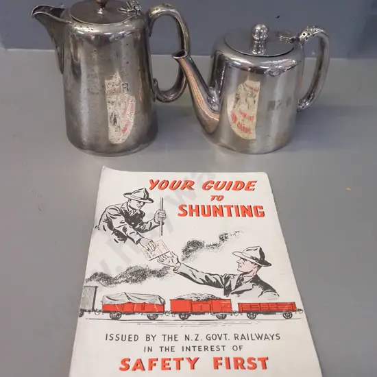 2 plated New Zealand Railways items - tea pot and hot water pot, both marked NZR, some wear and dents, plus a booklet on
