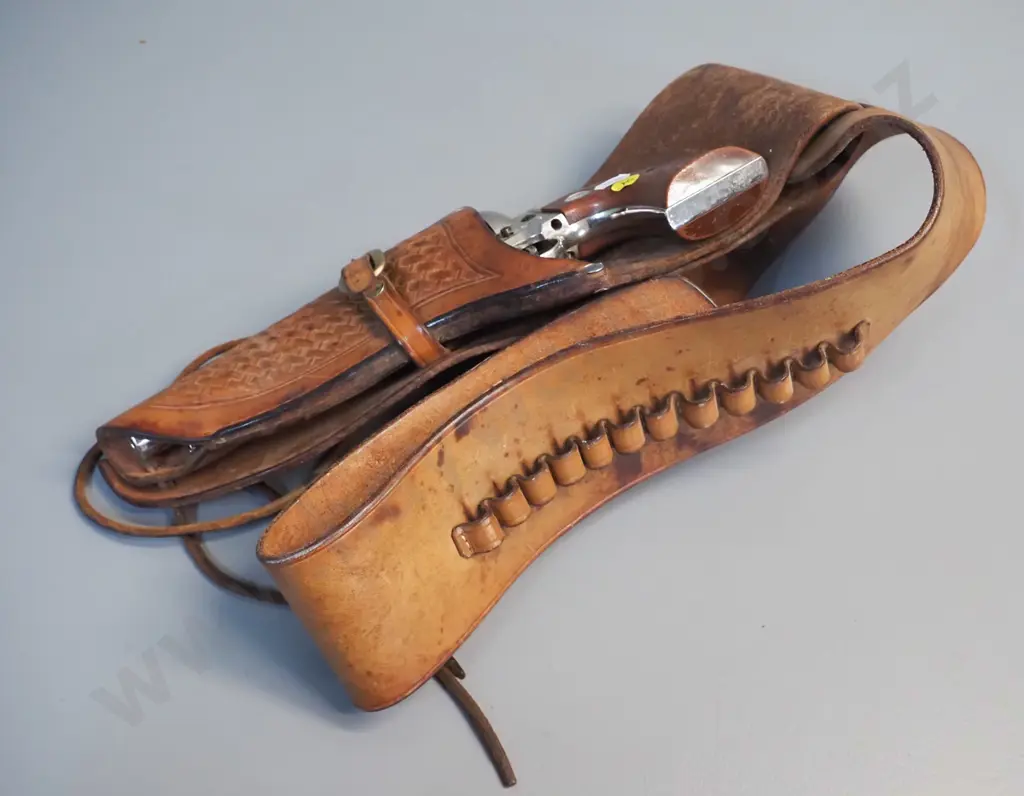 tooled leather gun belt and a vintage American style ornamental revolver. Image 1++