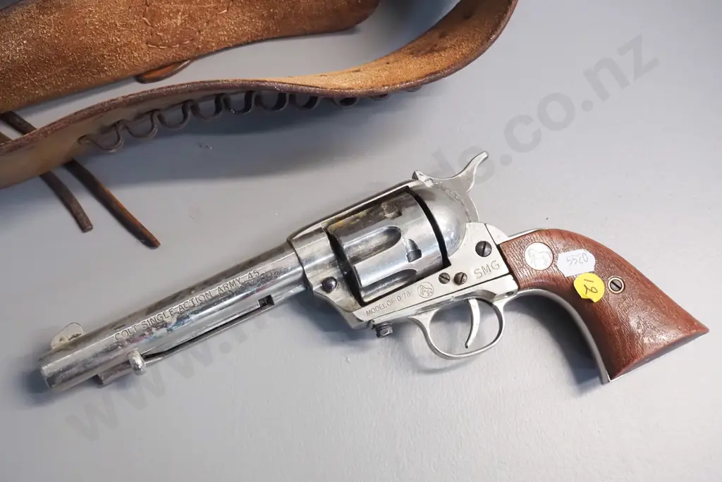 tooled leather gun belt and a vintage American style ornamental revolver. Image 1++