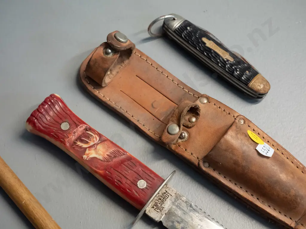 leather knife scabbard with 2 knives, ornamental leather item, rifle cleaner with wooden handle - larger knife marked Image 1++
