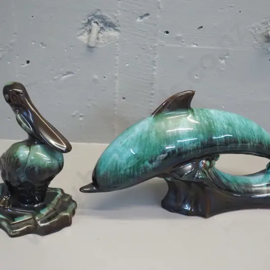 2 Blue Mountain pottery animal figures - leaping dolphin H-190 L-330 and a pelican H-190