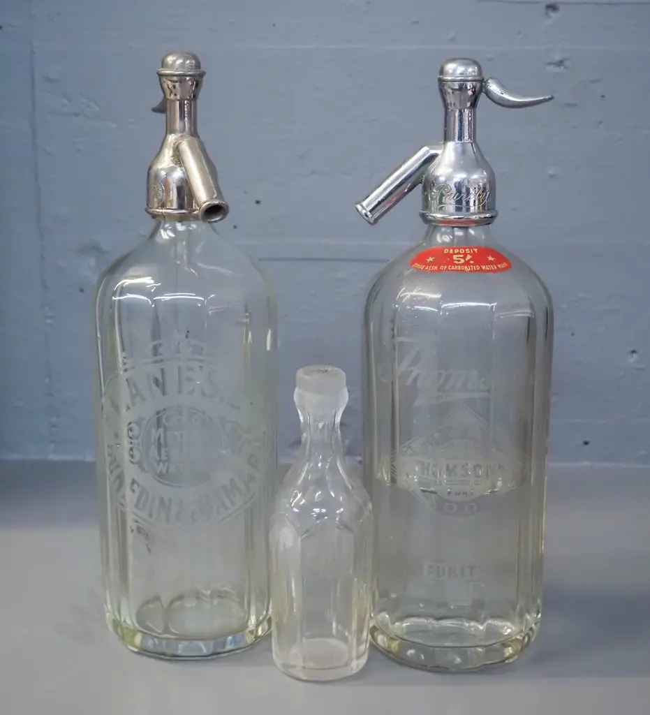 2 vintage soda syphons - Lane's Dunedin H310, Thomson's Dunedin & Oamaru, and a small crystal vinegar bottle, no stopper Image 1++