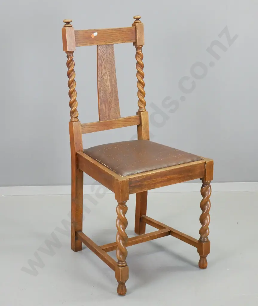 deco oak-framed dining chair with barley twist legs and back supports. Wear to brown leatherette seat. H-960 W-430 D-430 Image 1++