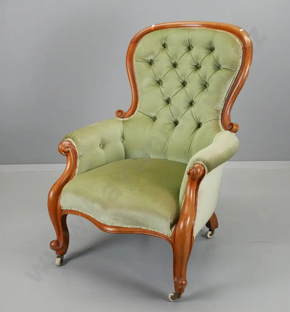 Victorian gent's mahogany framed lounge chair with deep button back, carved front legs, porcelain casters, green velvet Image 1++