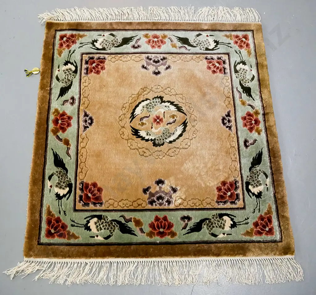 oriental rug, central medallion of two cranes, brown tonings, green border of cranes and flowers and mythical clouds Image 1++