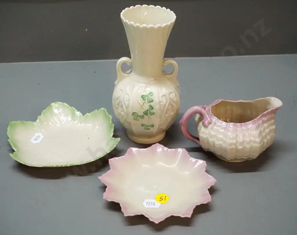 4 pieces of Belleek china, brown mark shamrock vase, black mark shell jug and 2 small plates Image 1++