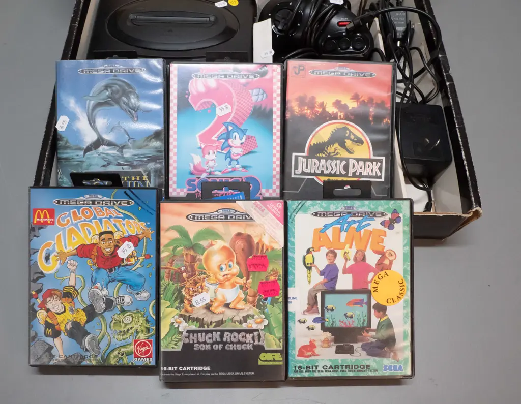 Sega Megadrive videogame console with 2 controllers, 6 game cartridges including Sonic Hedgehog, Jurassic Park etc. Image 1++