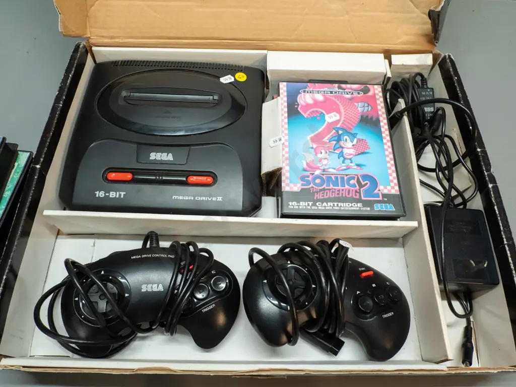 Sega Megadrive videogame console with 2 controllers, 6 game cartridges including Sonic Hedgehog, Jurassic Park etc. Image 1++