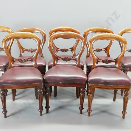 antique heavily carved mahogany dining suite with 8 studded burgundy leather balloon back chairs, oval crank extending