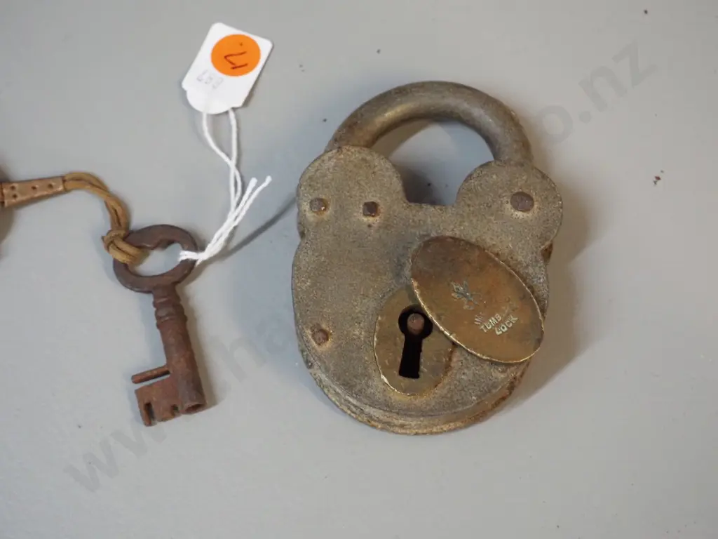 vintage padlock marked "Improved Tumbler Lock" with key on leather strap. Lock is H-100 W-70 Image 1++