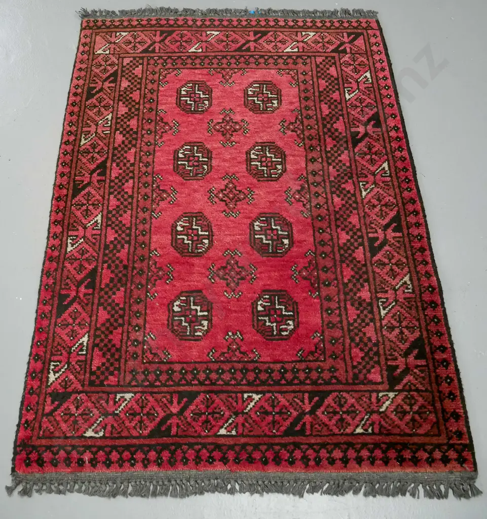 handknotted Turkoman rug, red ground, with central gul decoration and multiple geometric borders Image 1++