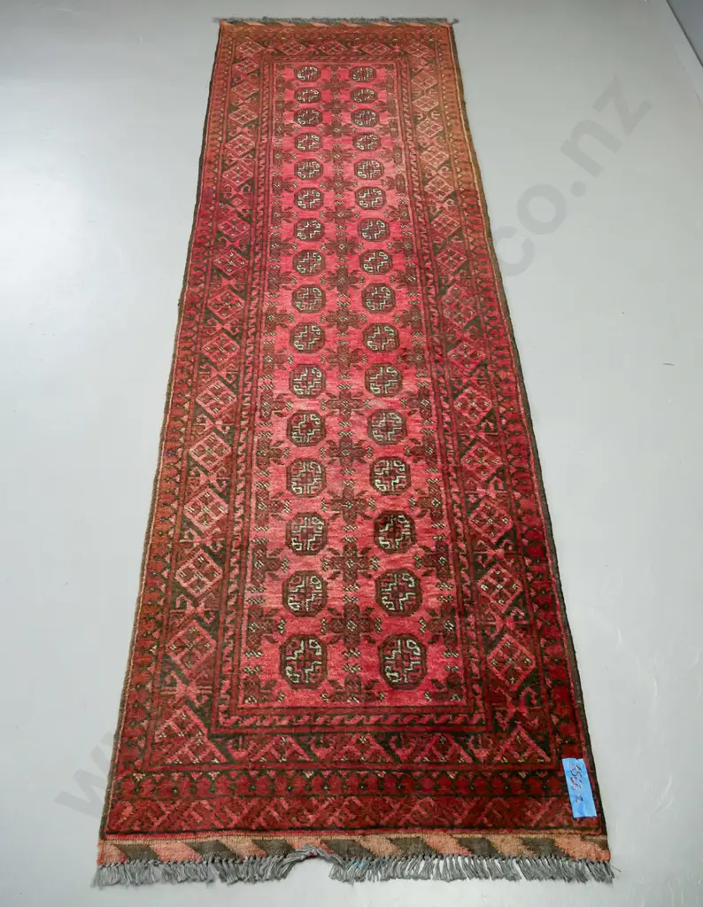 handknotted Turkoman red ground runner, central panel of guls, multiple borders with diamond decoration Image 1++