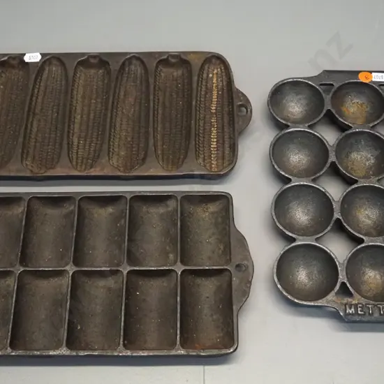 3 cast iron baking items - gem iron, corn bread mould and another marked Metters L-260 W-180