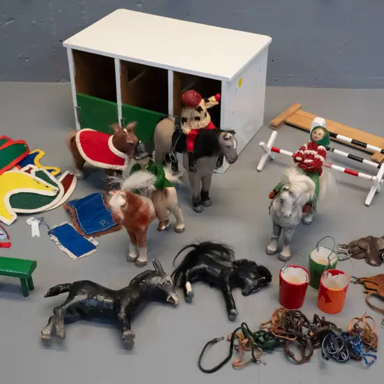 large collection of Julip horses, riders, and accessories, including saddles, blankets, harness, jumps, home-made