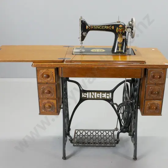 vintage oak cased Singer treadle sewing machine - 6 drawer cabinet on cast iron base, box of accessories H780 W880 D410