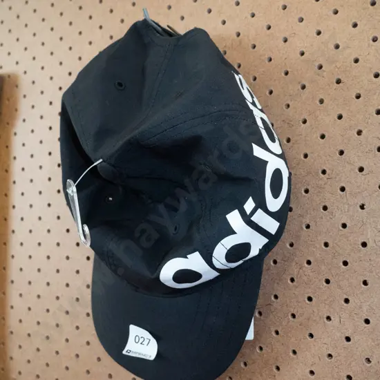Black Adidas Baseball Cap with Rebel Sport sales label attached 