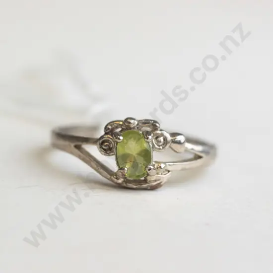 silver ring with green-coloured stone in set