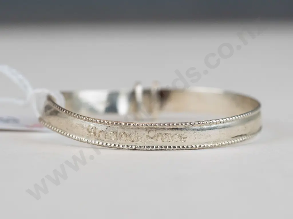 Silver child's bracelet with ""Ariana Grace"" engraved on front and ""05/12/23"" on the inside Image 1++