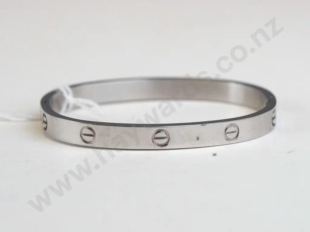 Silver bracelet, circle designs around the edges. Clasp closing.  Image 1++
