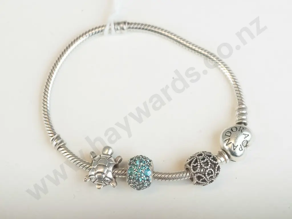 Pandora silver bracelet with four charms. Image 1++