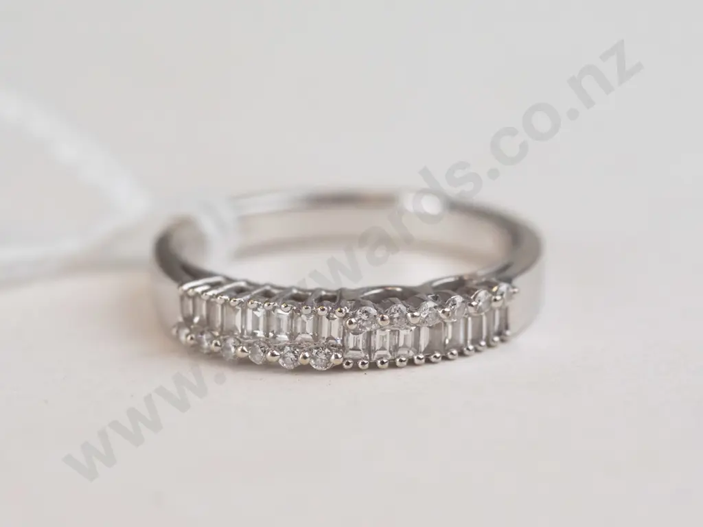 A silver ring with diamond-like material of the top. Image 1++