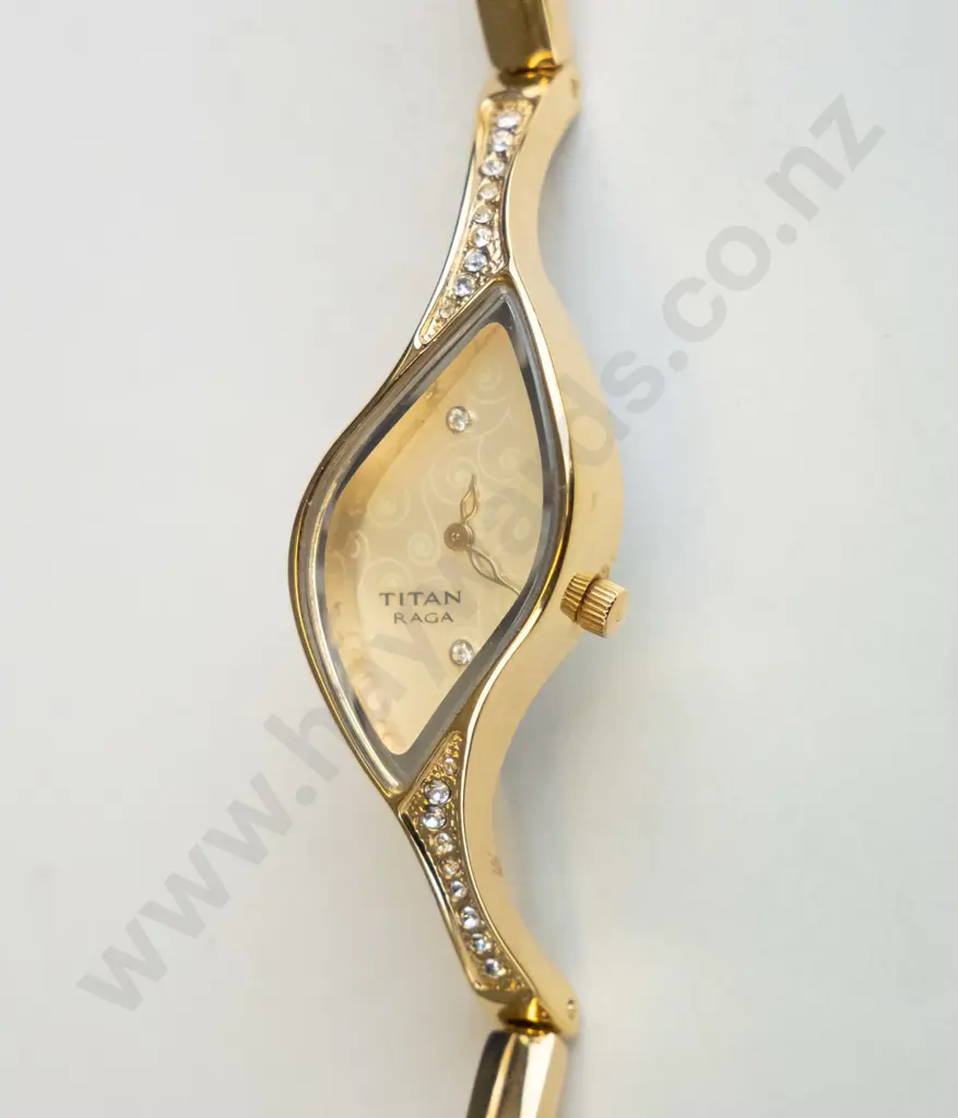 gold coloured diamond shaped watch with white stones Image 1++